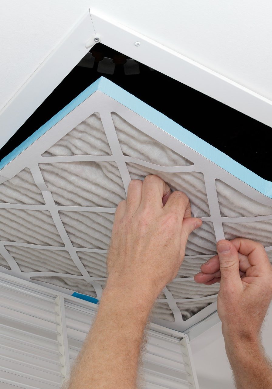 Air quality page image Man taking old dirty air filter out