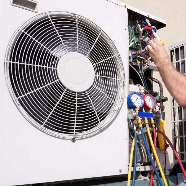 Employee working on repairing an ac unit